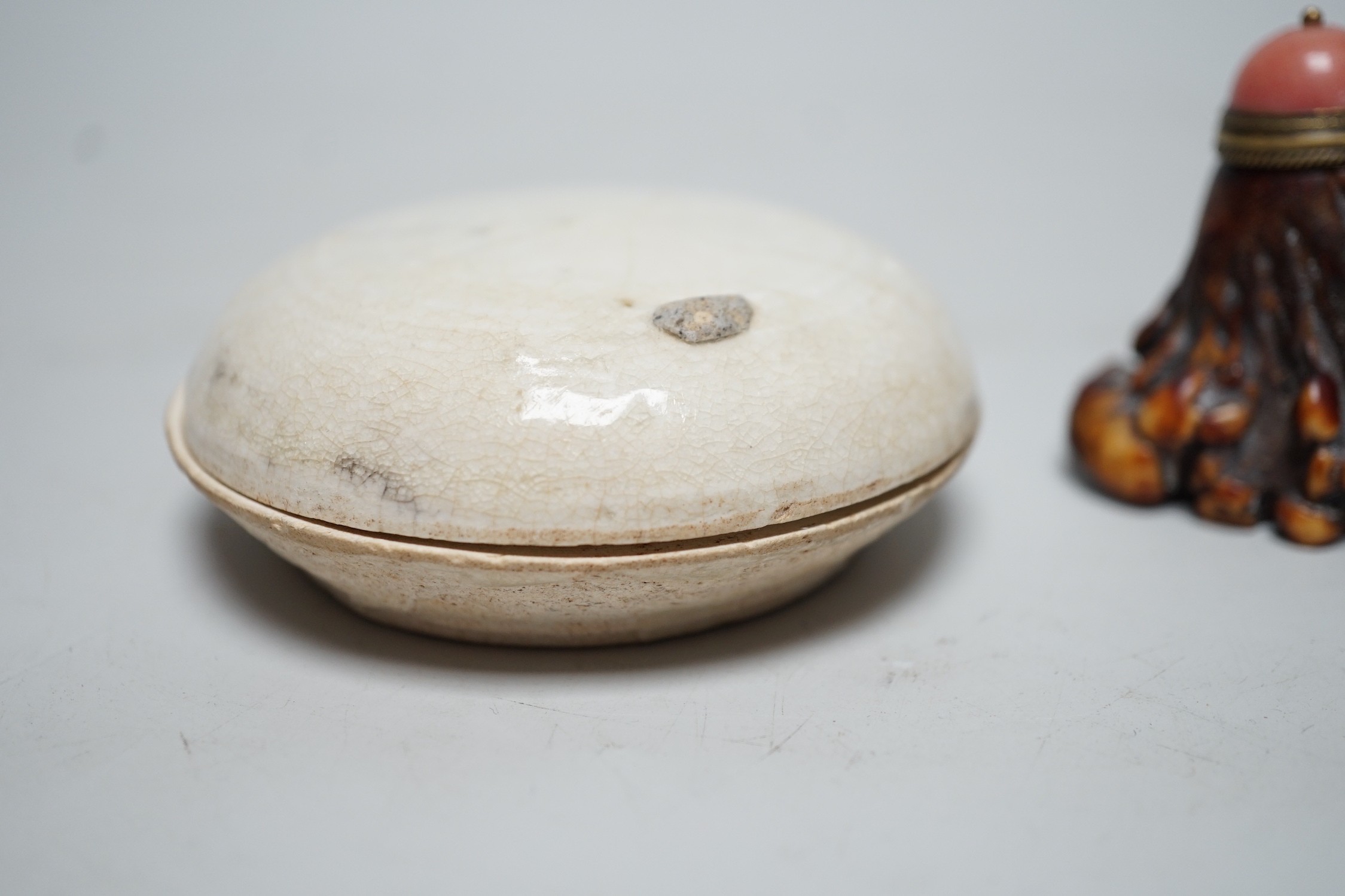 A Chinese box and cover, Fujian kilns, Yuan dynasty, 8cm together with a stag antler snuff bottle